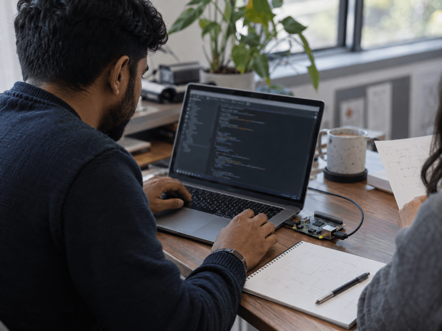 Illustrative scene of an engineer working with software and a connected development board